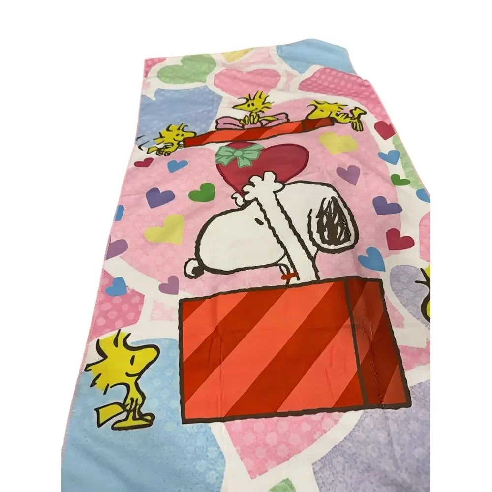 Snoopy peanuts come out of a present beach towel
